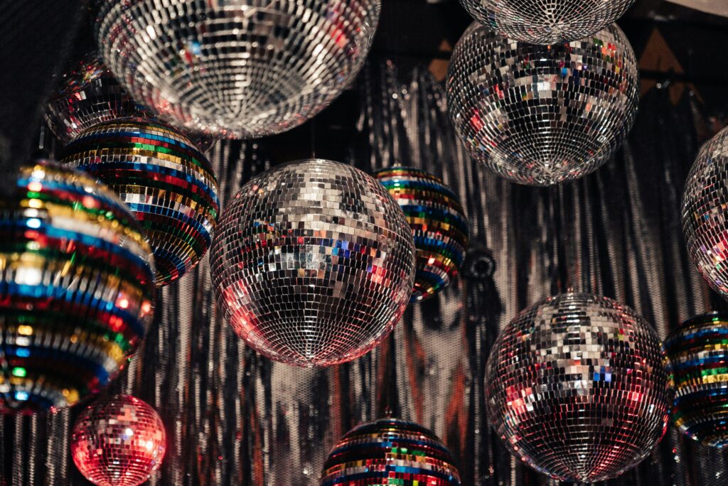 Image shows mirrorballs from a 1970s disco murder mystery party game